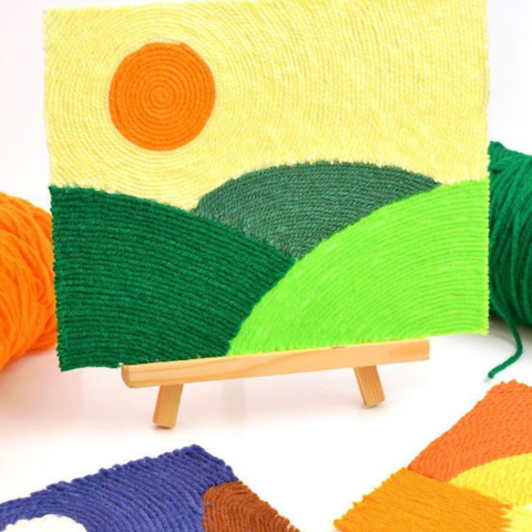 a small landscape art made with colored yarn