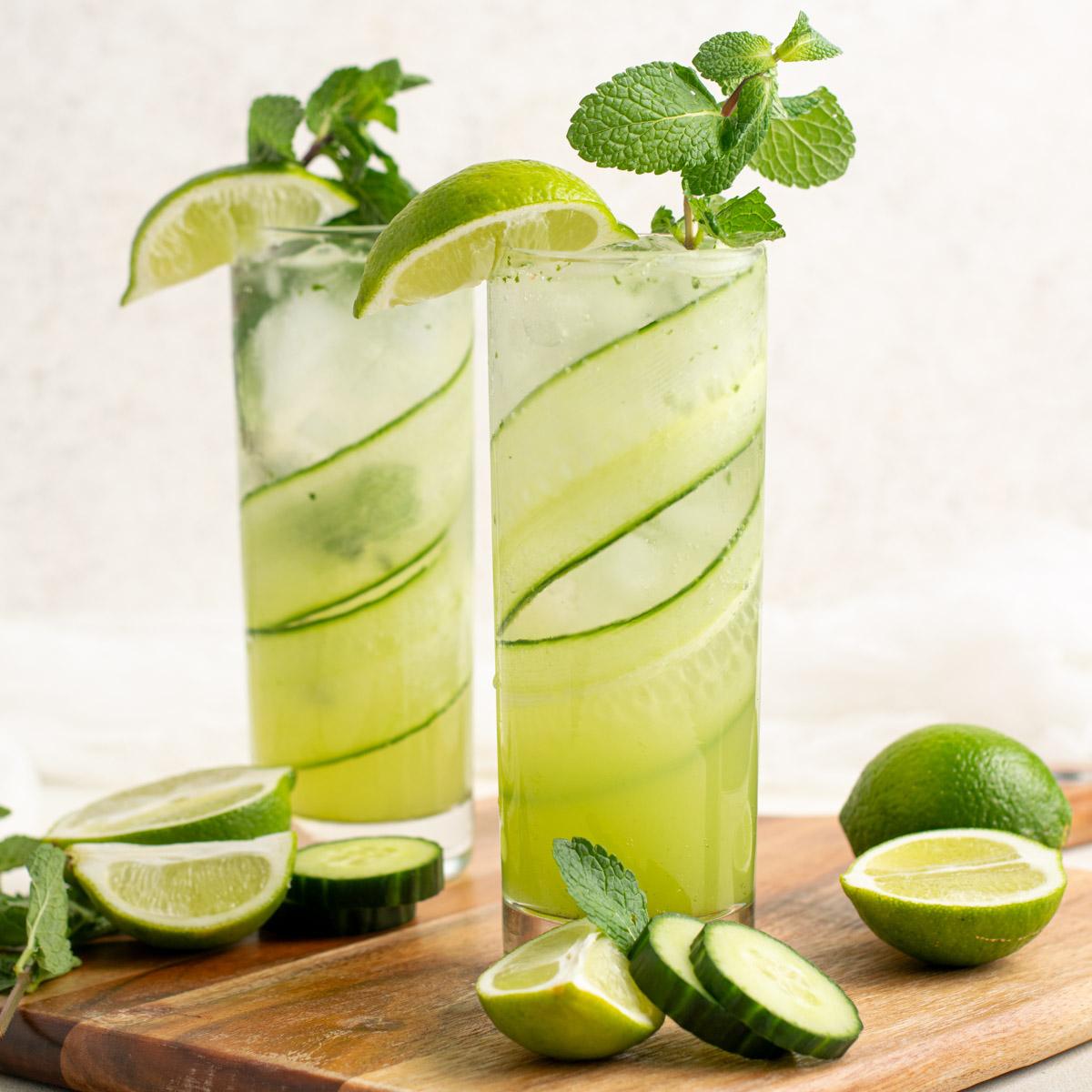 two glasses with cucumber mojitos